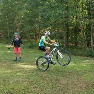 Women doing a wheelie on a mountain bike