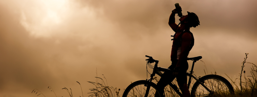 cyclist hydrating in the heat