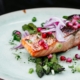 Grilled salmon fillet with asparagus and pomegranate, highlighting nutrition strategies for sleep and mental health.